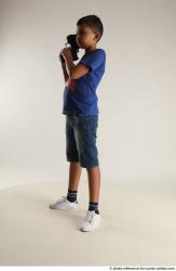 TIMBO STANDING POSE WITH GUN